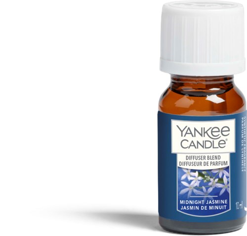 En liten brun flaska med vit topp och en blå etikett som säger "Yankee Candle" och "Midnight Jasmine."