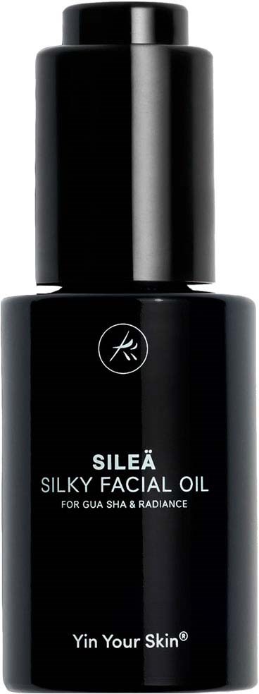 Musta pullo SILEÄ Silky Facial Oil -tuotteesta ihon hehkua ja säteyttä varten yksinkertaisella valkoisella tekstillä.