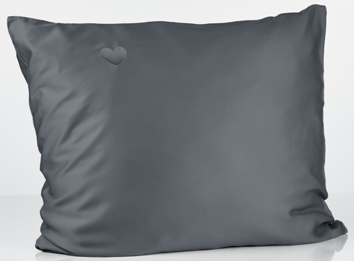 A gray pillow with a small heart embroidery in the top left corner.