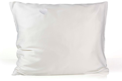 A white pillow with a small tear near the top left corner.