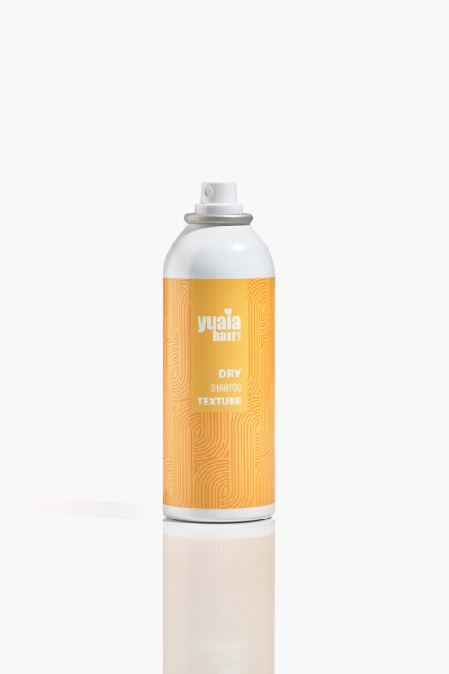 A white spray bottle with an orange label that says 'Yuaia Texture Dry Shampoo'.