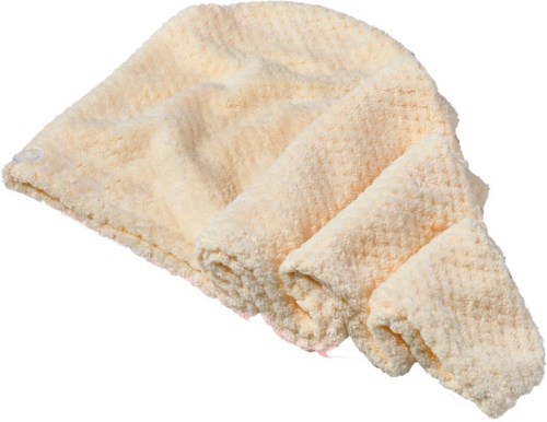A soft, beige cloth or towel with a textured surface, partially rolled up and lying flat.