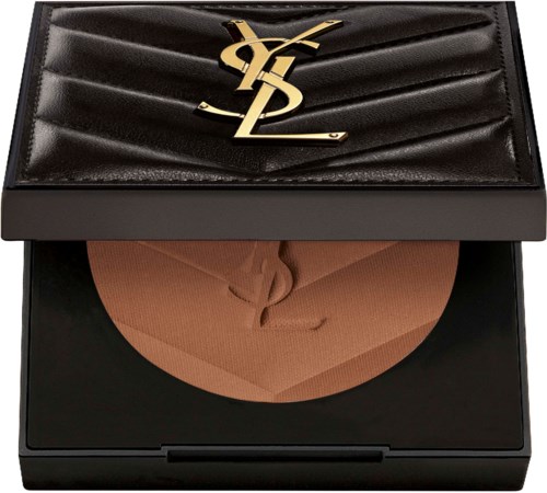 A black compact case with a gold YSL logo, open to show beige powder inside.