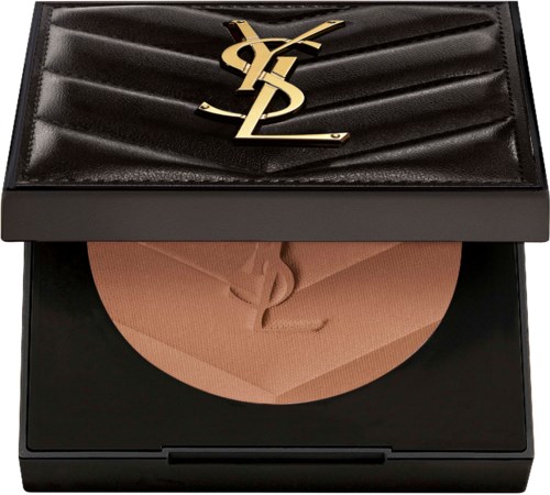A black wallet with a gold logo and a blush-colored powder compact inside. The wallet has a quilted pattern.