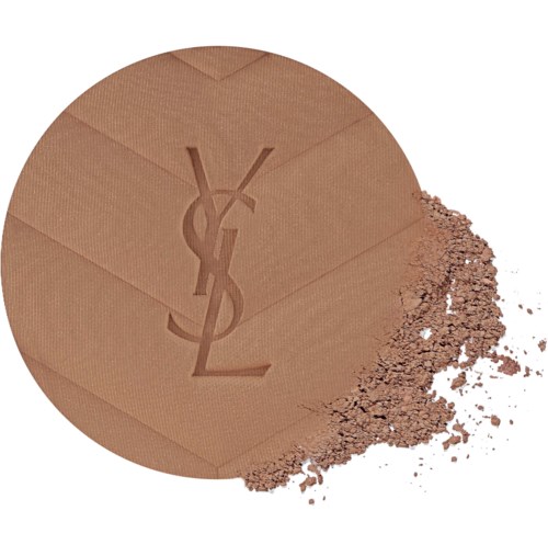A beige YSL powder compact with the YSL logo embossed, some powder spilled out on a white surface.