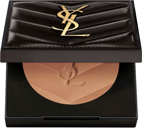 A makeup compact with a beige pressed powder and a luxurious black case with a gold logo on top.