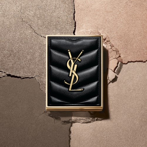 A black box with a YSL logo is on a cracked wall. The box looks elegant and luxurious.