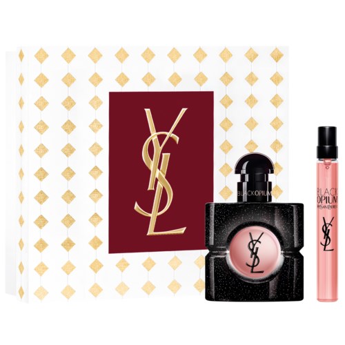 Yves Saint Laurent -logo ja setti meikkituotteita, kuten vaaleanpunainen huulikiilto ja pieni hajuvesipullo.