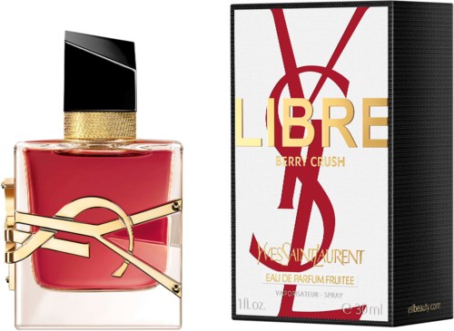 A perfume bottle with a black and gold cap and red liquid, next to a white box with red and gold text.