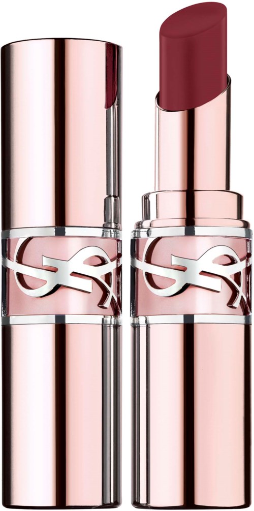 A pink lipstick in a shiny, rose gold case with a logo, against a black background.