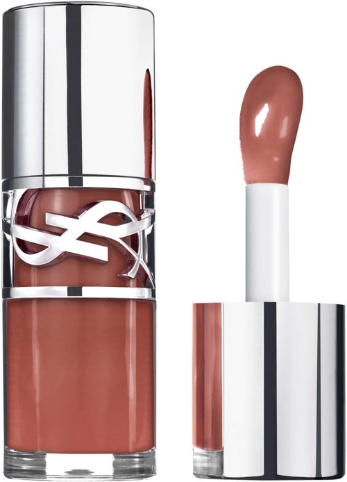 A lipstick tube with glossy silver cap and a pulled-out, nude-colored lipstick. The tube displays a logo.