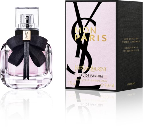 Een parfumfles met een zwart lint en strik, en een doos met gouden en zwarte tekst die Yves Saint Laurent zegt.