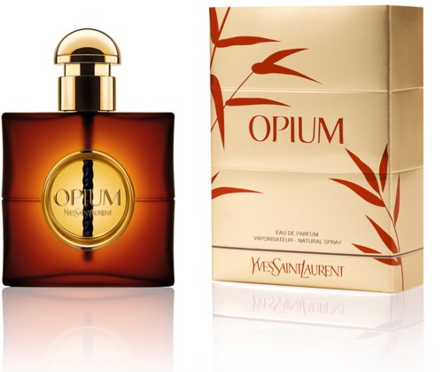 A perfume bottle with a gold cap and a box with red leaves and text that says "OPIUM" by Yves Saint Laurent.