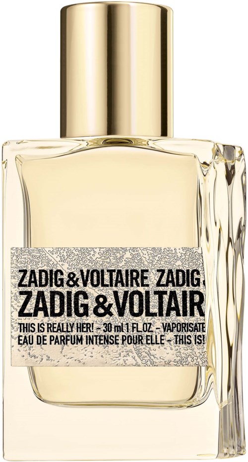 Ein Parfümflasche mit goldener Kappe und einem Etikett, das 'Zadig & Voltaire' und 'This is Really Her!' liest.