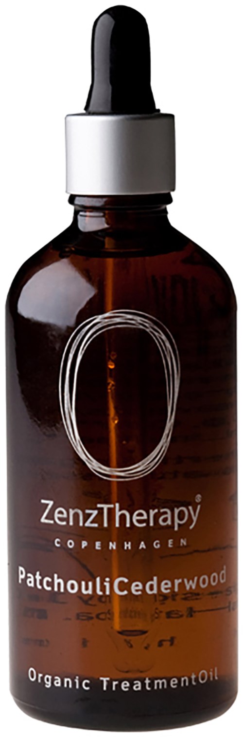 Eine braune Glasflasche mit Pipettenverschluss, beschriftet 'ZenzTherapy Copenhagen Patchouli Cederwood Organic Treatment Oil.'