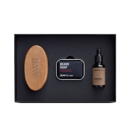 A grooming kit contains a wooden beard brush, soap, and beard oil in a box.