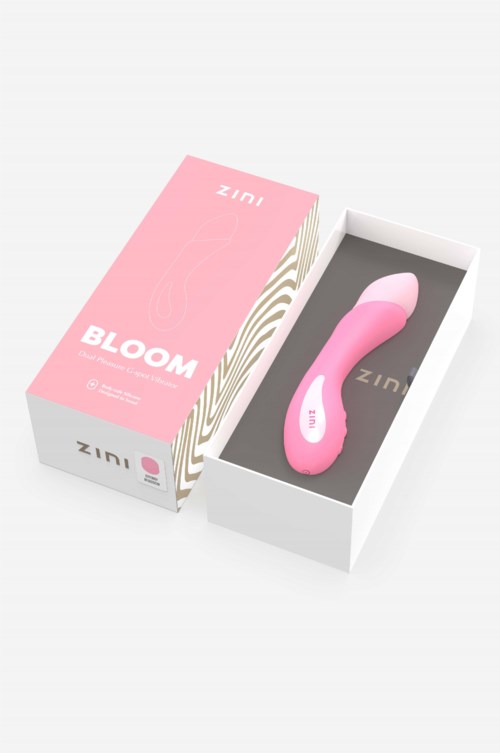 Ein rosa, gebogener Gerät mit der Aufschrift ZINI in einer weißen Box mit rosa und beigem Deckel. Die Box trägt die Aufschrift BLOOM.