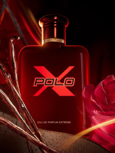 A red perfume bottle with a rose beside, labeled Polo X Eau de Parfum Extreme, on a dark background.