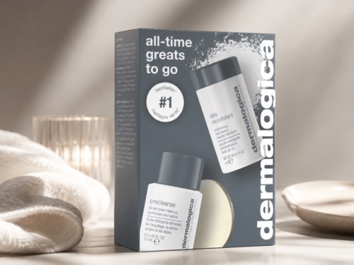 Skincare products in packaging with logo and product details, set on a soft surface with decorative bowls and a candle in the background.